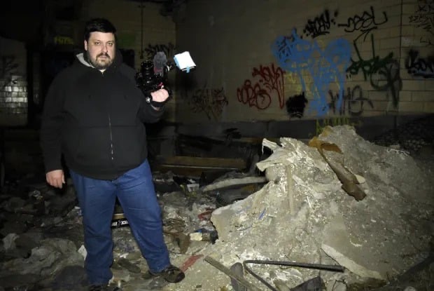 Dan Bell filming in an abandoned location